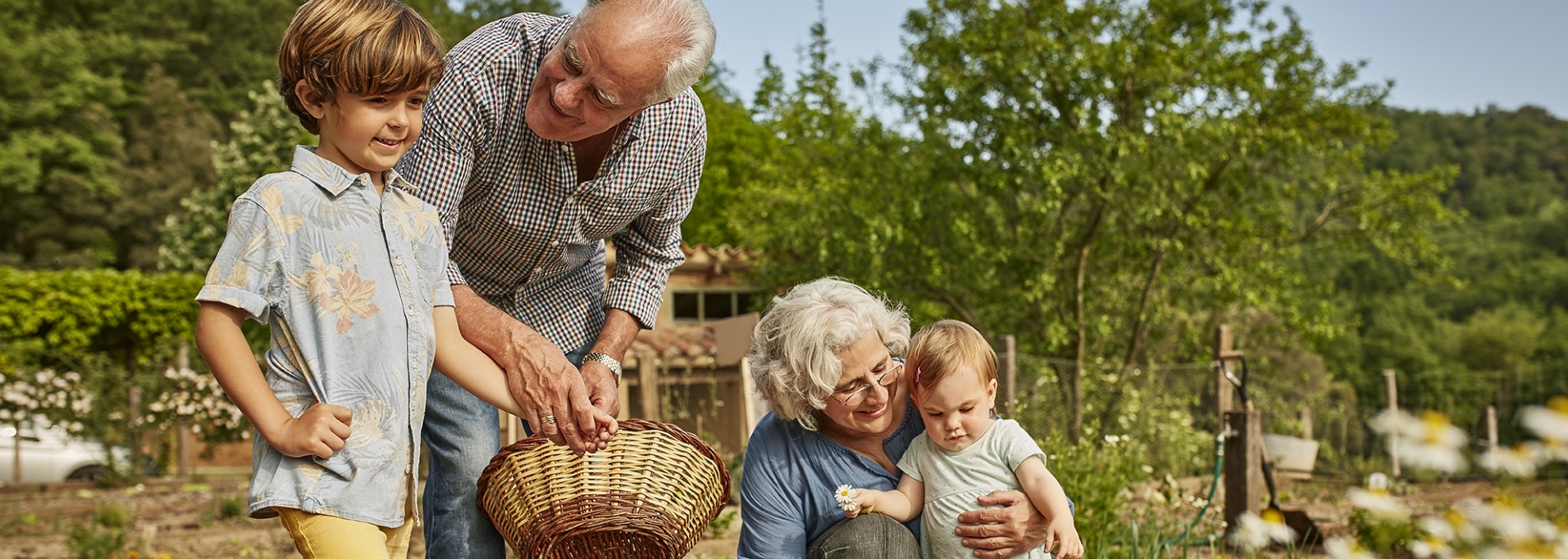 Grandparents enjoying with children in yard